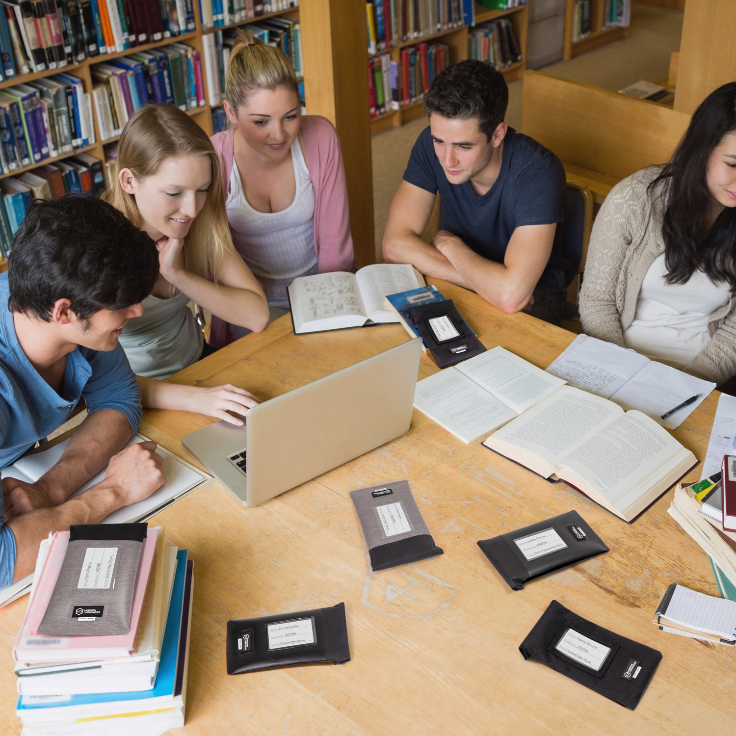 Students studying with Generation Faraday bags in library